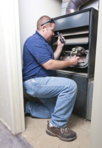 technician-inspecting-inside-of-furnace