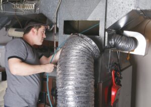 technician-working-on-hvac-ductwork